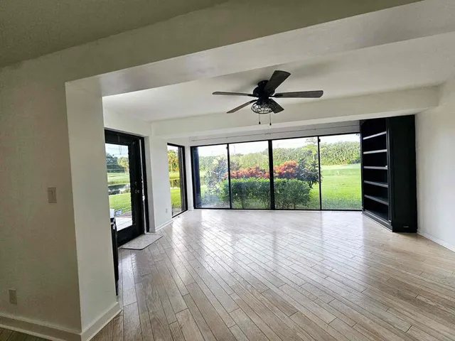 a view of an empty room and wooden floor
