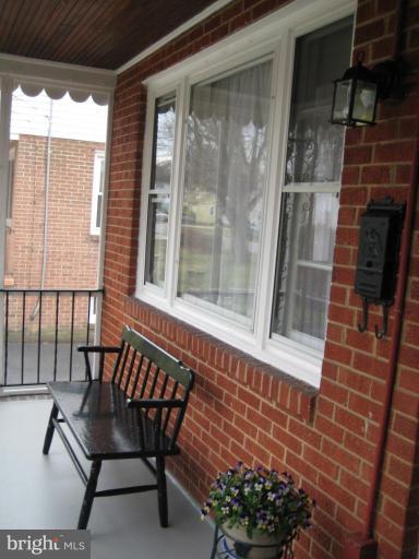 8120 Hillendale Road Parkville, MD 21234 - Photo 2 of 16 a balcony with table and chairs and potted plants