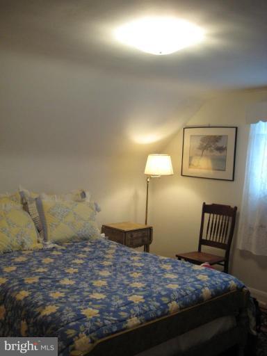 8120 Hillendale Road Parkville, MD 21234 - Photo 12 of 16 a bedroom with a bed and painting on the wall
