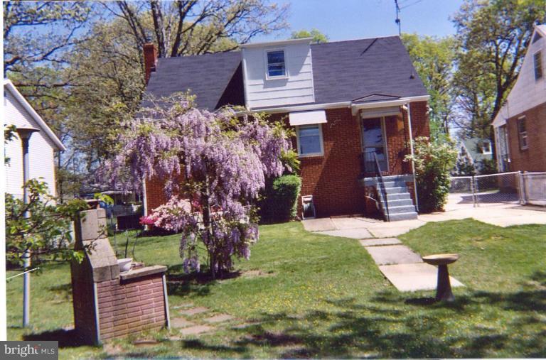 8120 Hillendale Road Parkville, MD 21234 - Photo 16 of 16 a front view of a house with a garden and trees