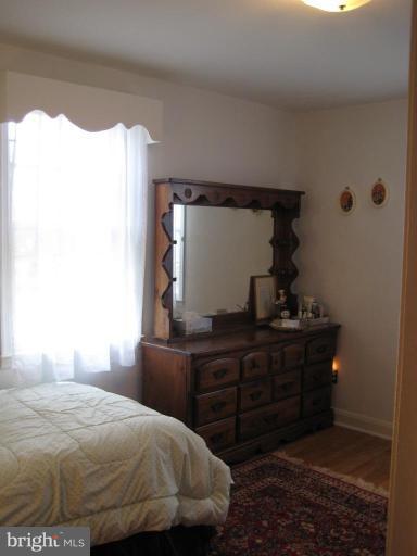 8120 Hillendale Road Parkville, MD 21234 - Photo 7 of 16 a bedroom with a bed and a dresser