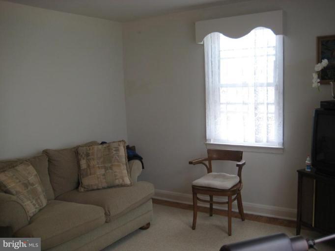 8120 Hillendale Road Parkville, MD 21234 - Photo 8 of 16 a living room with furniture and a flat screen tv