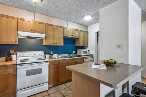 a kitchen with a stove cabinets and sink