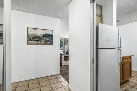 a kitchen with granite countertop a sink stove and cabinets