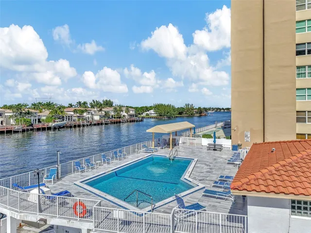 a view of a lake with couches and wooden floor
