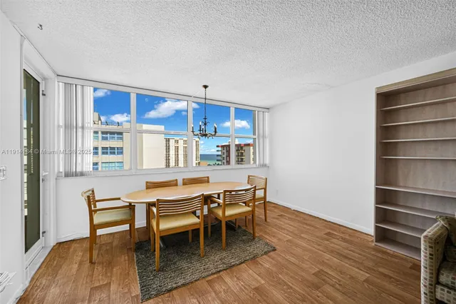 a dining room with furniture and wooden floor