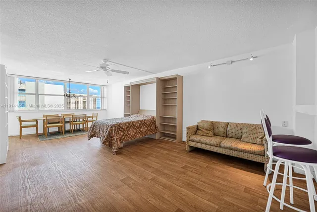 a living room with a bed furniture and a large window
