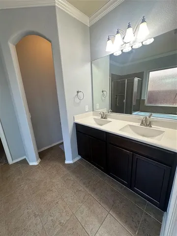 a bathroom with a double vanity sink and a mirror