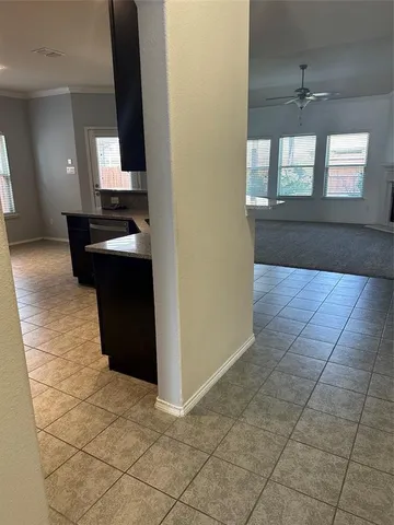 a kitchen with granite countertop a rug a stove and a window