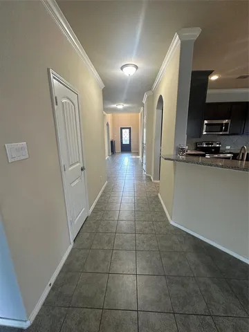 a view of a hallway with wooden floor and furniture