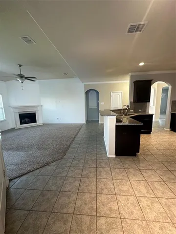 a kitchen with stainless steel appliances kitchen island granite countertop a sink and cabinets