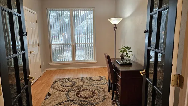 a view of a hallway to a livingroom with furniture
