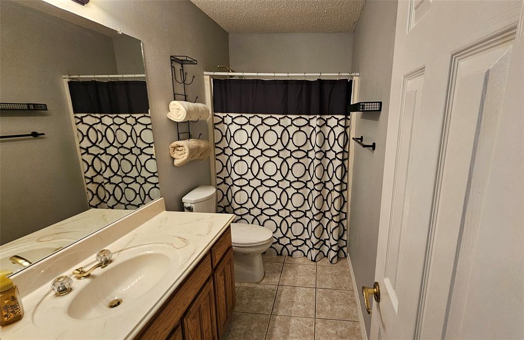 7529 Whitestone Ranch Road Benbrook, TX 76126 - Photo 19 of 26 a bathroom with a sink toilet and shower