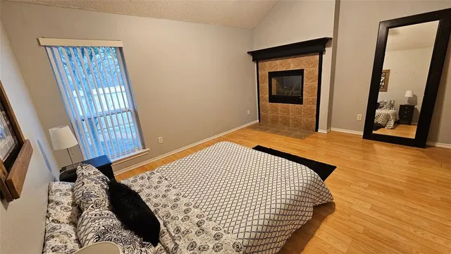 a bedroom with a bed and a window