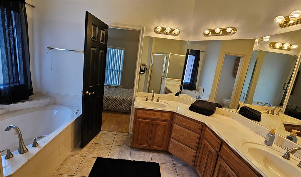 7529 Whitestone Ranch Road Benbrook, TX 76126 - Photo 22 of 26 a bathroom with a tub sink and mirror