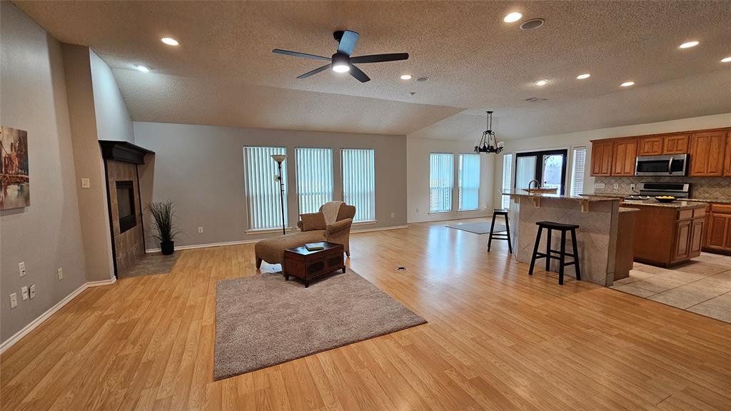 7529 Whitestone Ranch Road Benbrook, TX 76126 - Photo 8 of 26 a living room with furniture and a wooden floor
