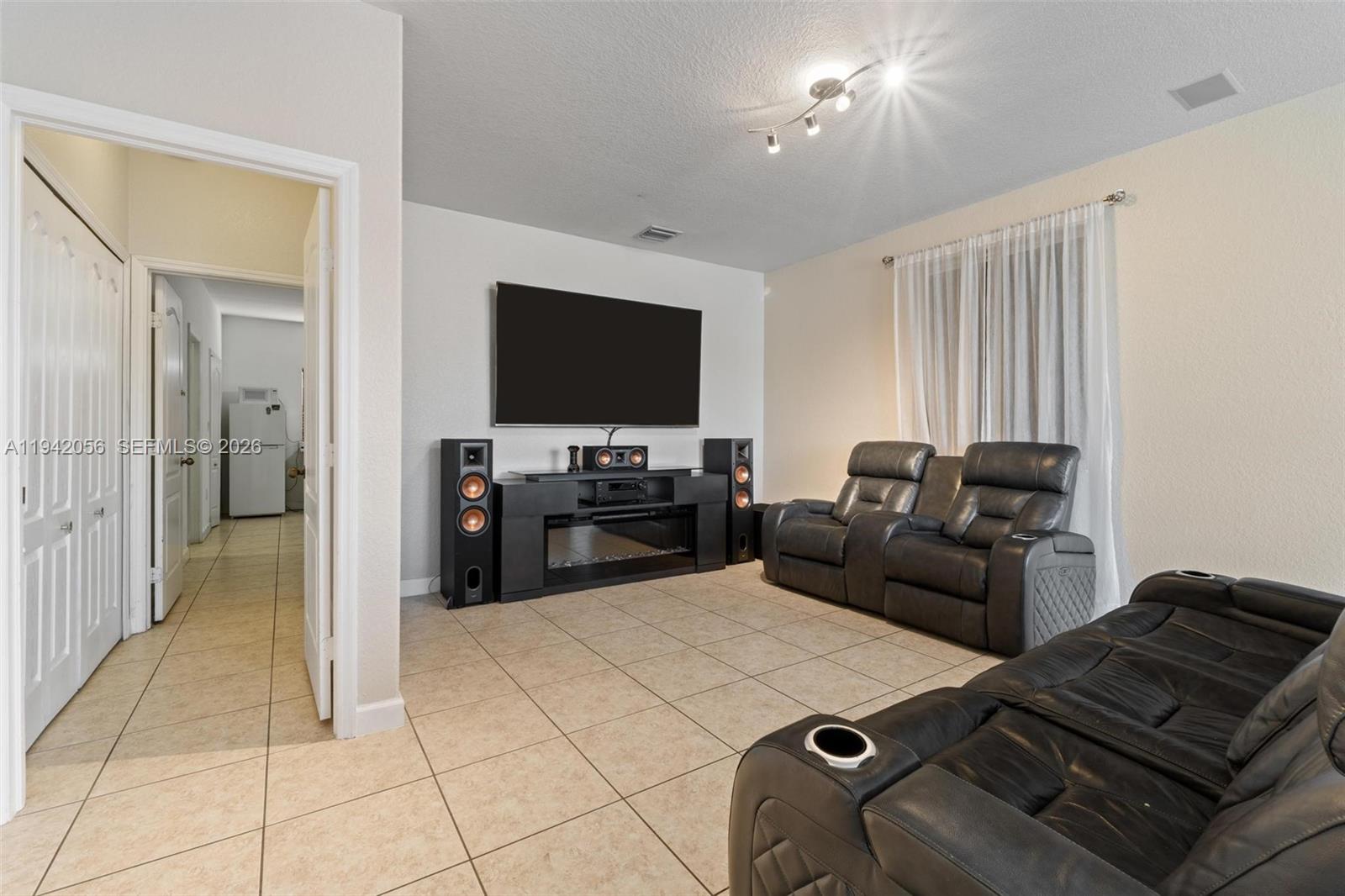 16301 Southwest 70th Street Miami, FL 33193 - Photo 20 of 56 a living room with furniture and a flat screen tv