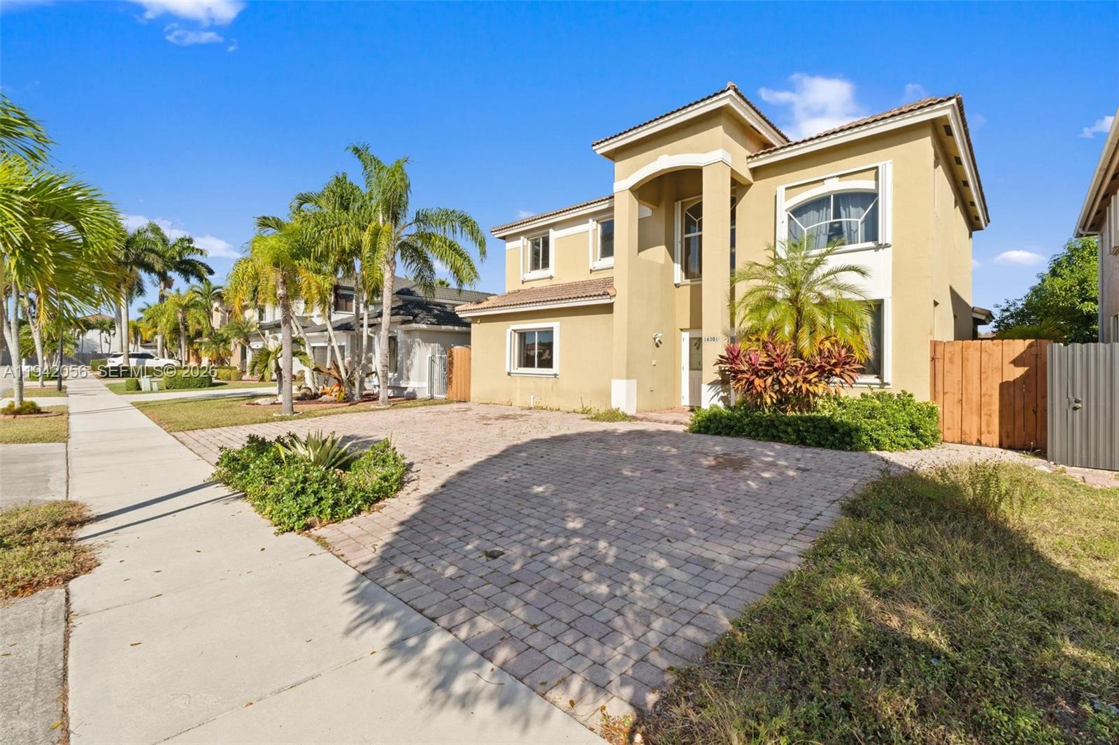 16301 Southwest 70th Street Miami, FL 33193 - Photo 2 of 56 a front view of a house with garden