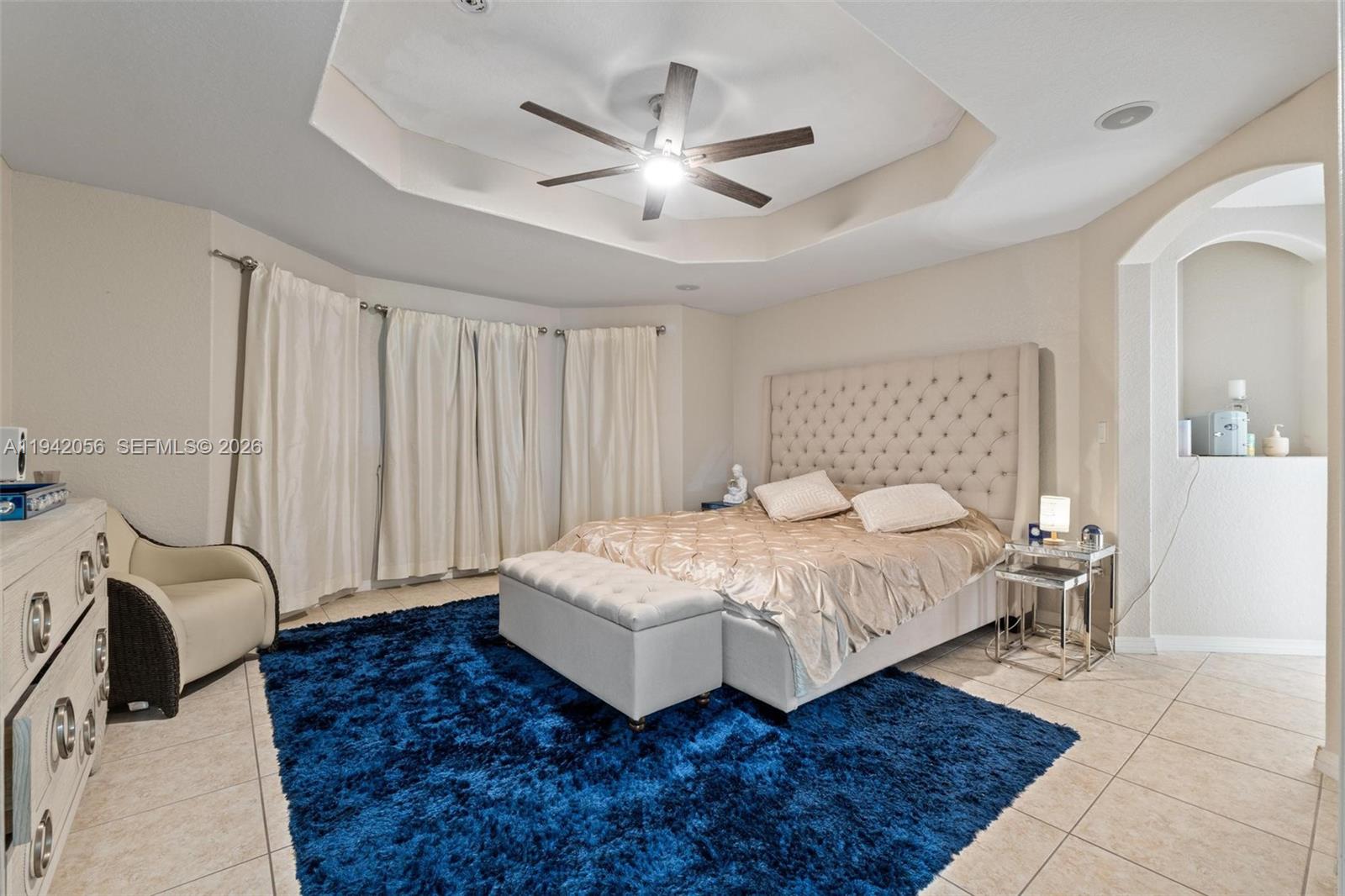 16301 Southwest 70th Street Miami, FL 33193 - Photo 28 of 56 a spacious bedroom with a bed and a chandelier
