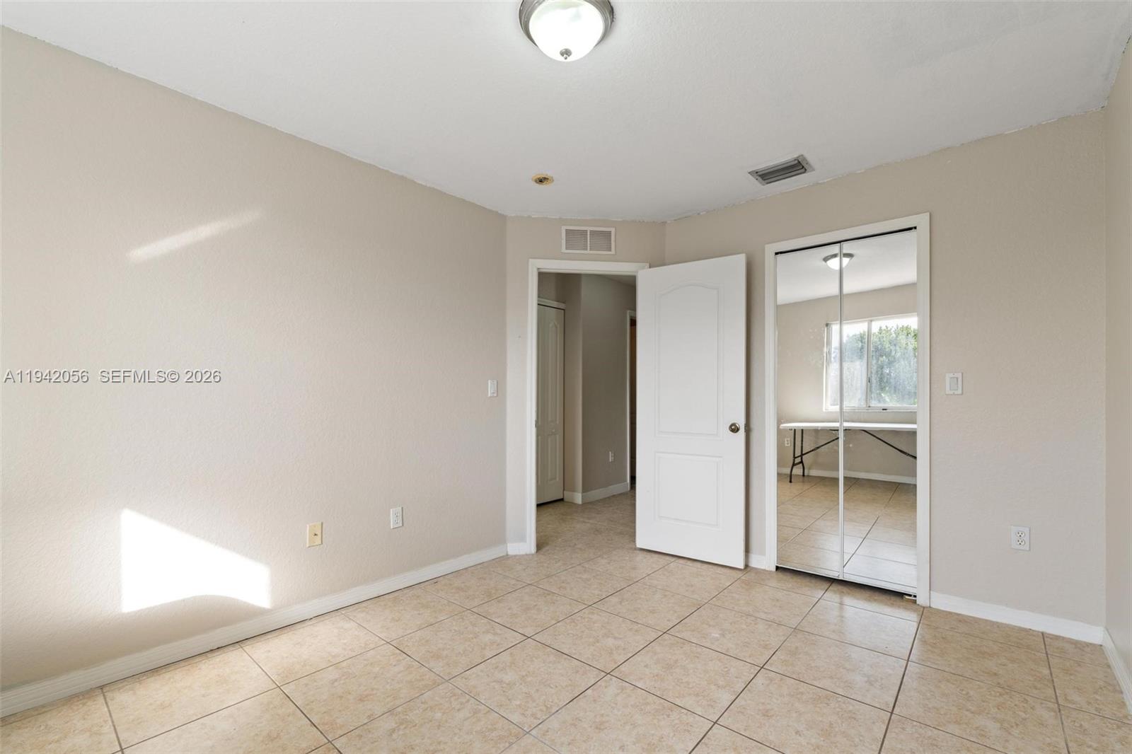 16301 Southwest 70th Street Miami, FL 33193 - Photo 36 of 56 a view of an empty room with window and cabinet