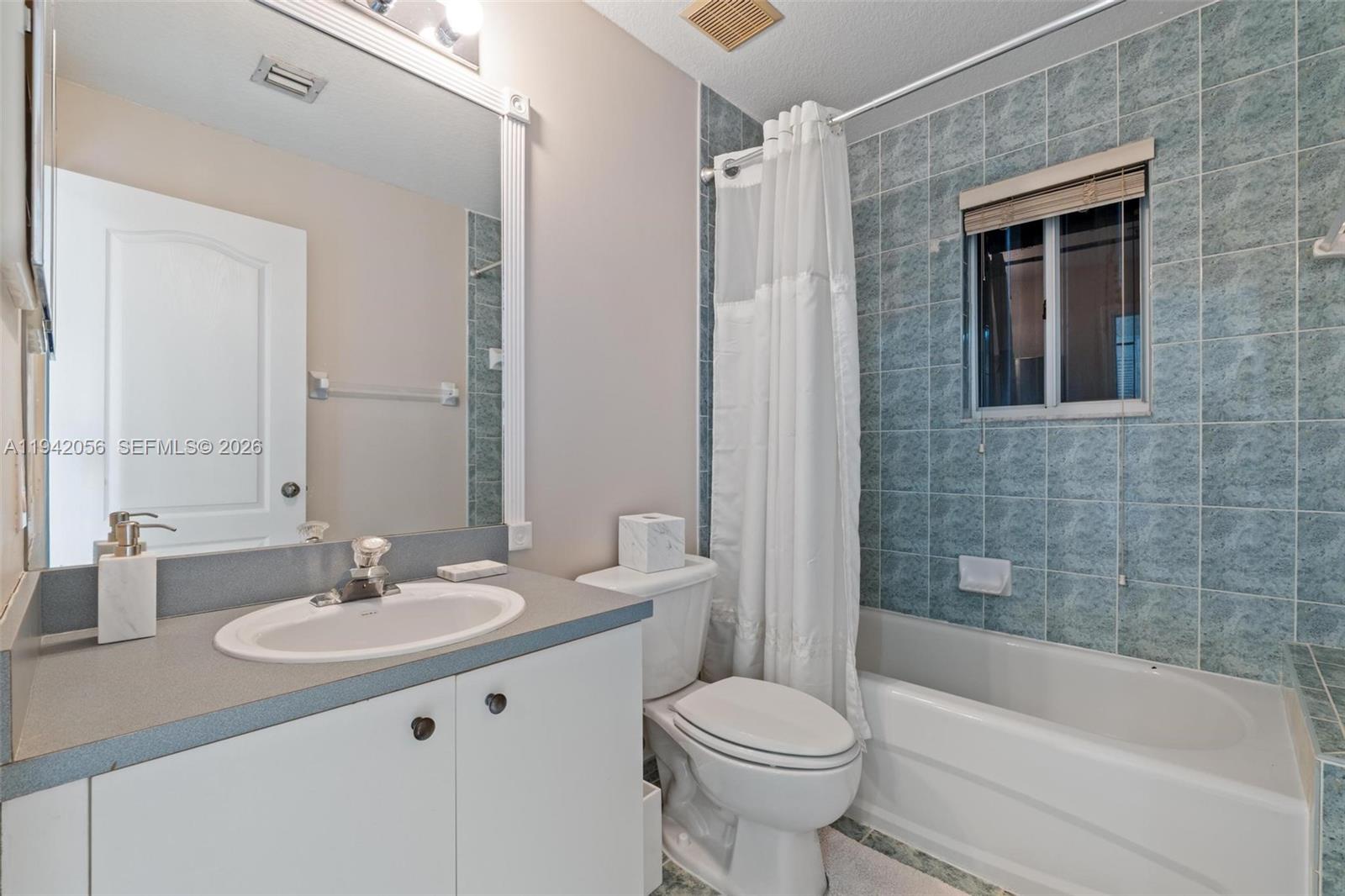 16301 Southwest 70th Street Miami, FL 33193 - Photo 39 of 56 a bathroom with a sink a toilet and shower