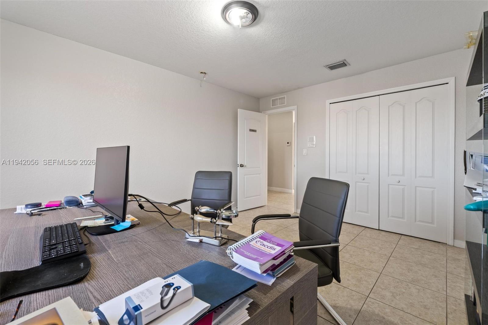 16301 Southwest 70th Street Miami, FL 33193 - Photo 41 of 56 a workspace with furniture and wooden floor