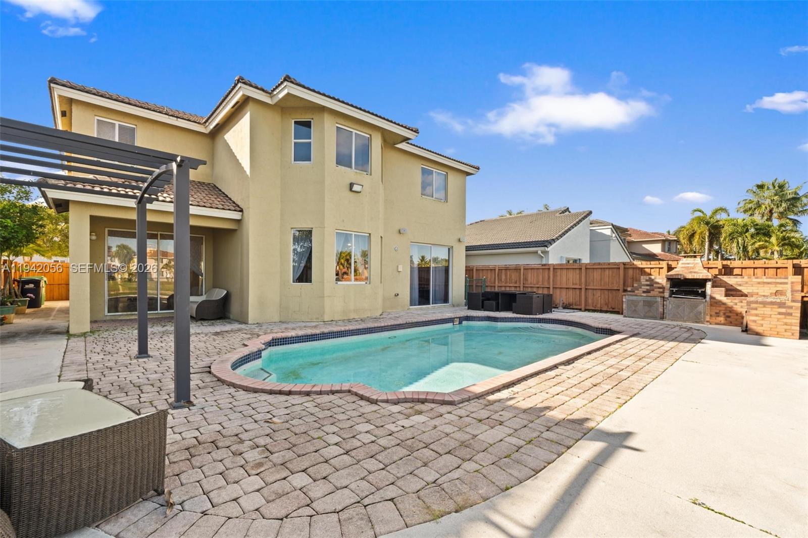 16301 Southwest 70th Street Miami, FL 33193 - Photo 43 of 56 a front view of a house with swimming pool having outdoor seating