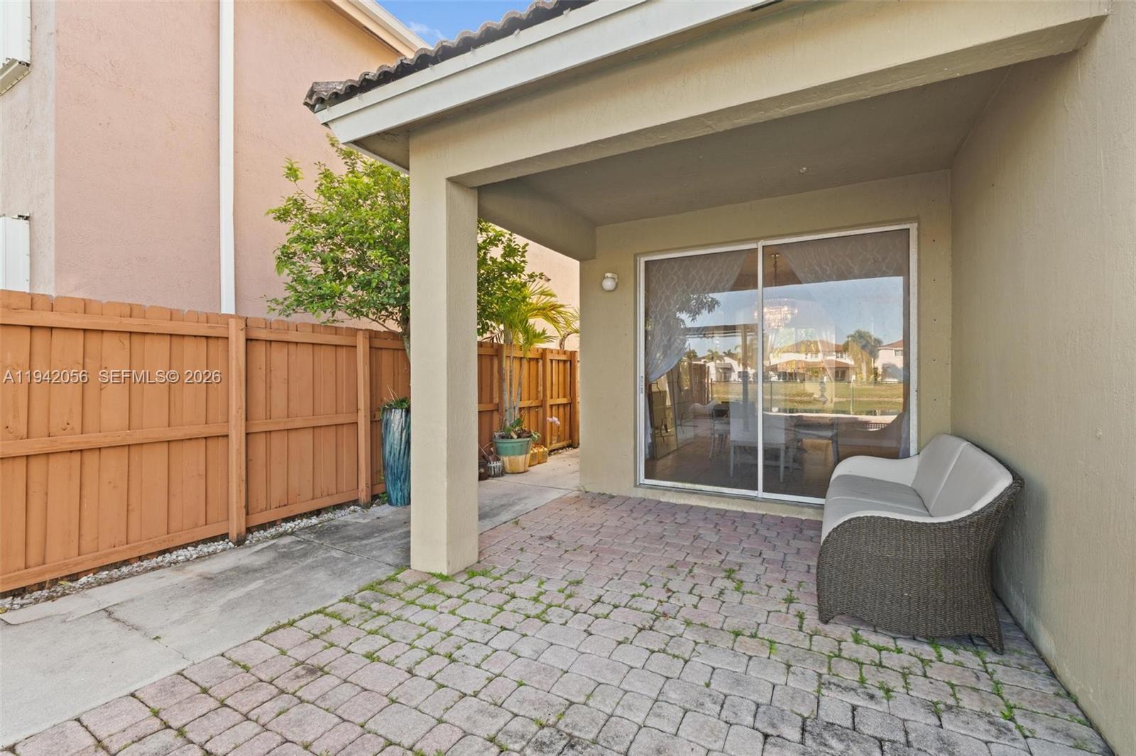 16301 Southwest 70th Street Miami, FL 33193 - Photo 45 of 56 a view of a porch with furniture and floor to ceiling window
