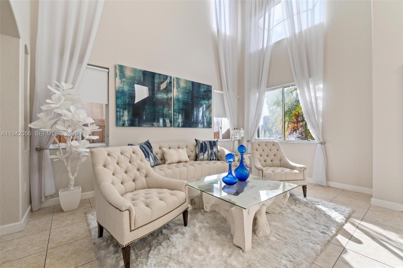 16301 Southwest 70th Street Miami, FL 33193 - Photo 5 of 56 a living room with furniture and a large window