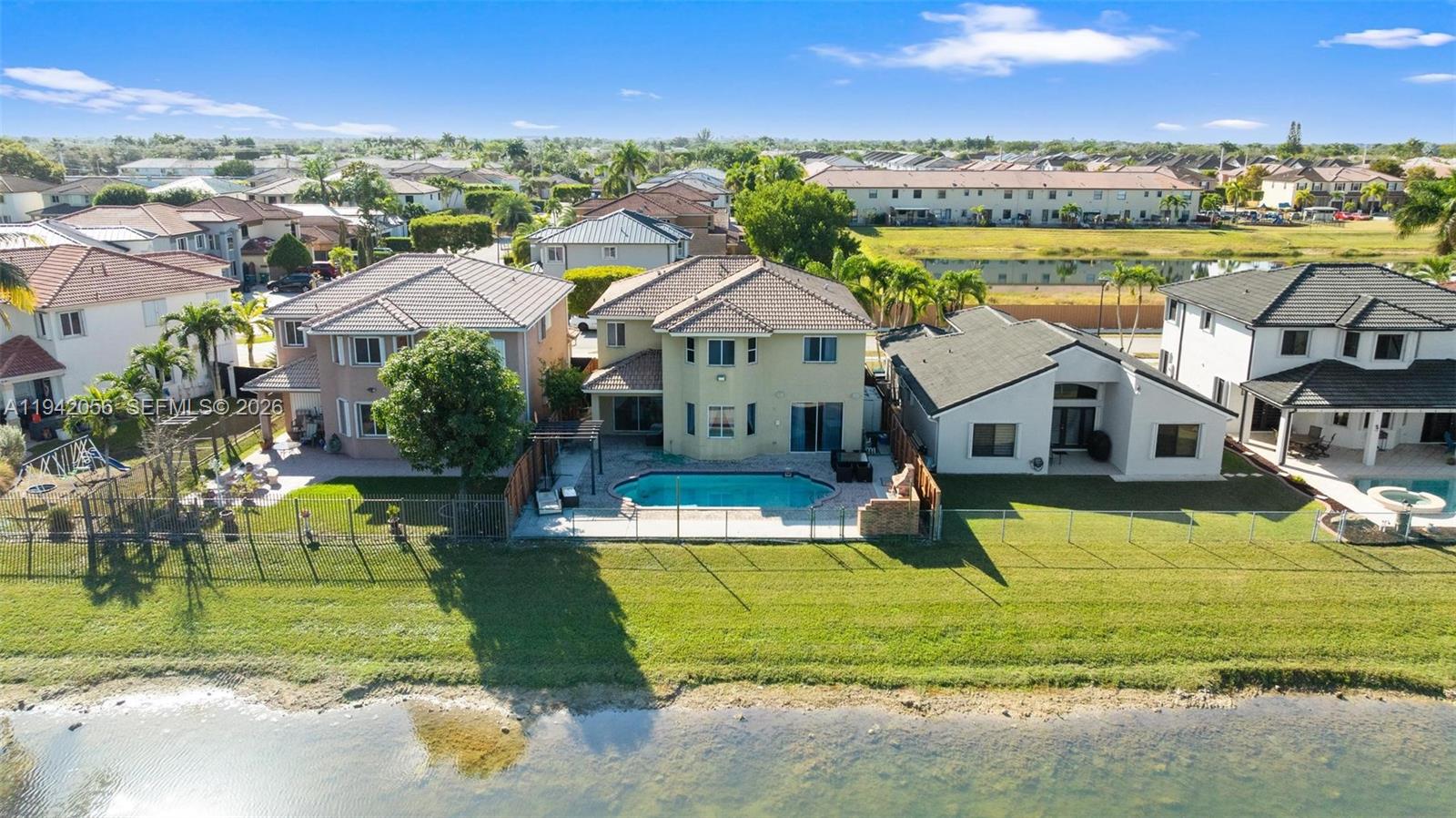 16301 Southwest 70th Street Miami, FL 33193 - Photo 56 of 56 a view of a house with a swimming pool and a yard