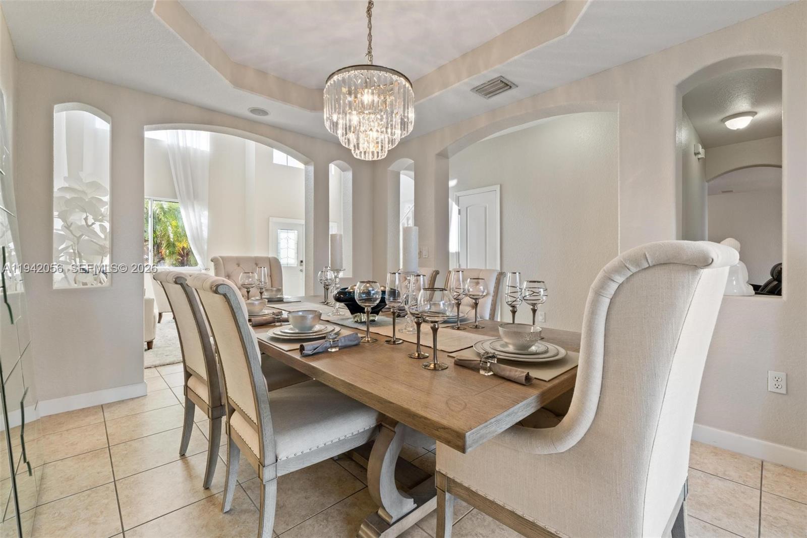 16301 Southwest 70th Street Miami, FL 33193 - Photo 9 of 56 a view of a dining room with furniture and a chandelier