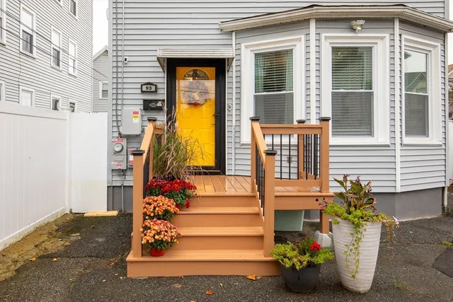 a view of a house with potted plants