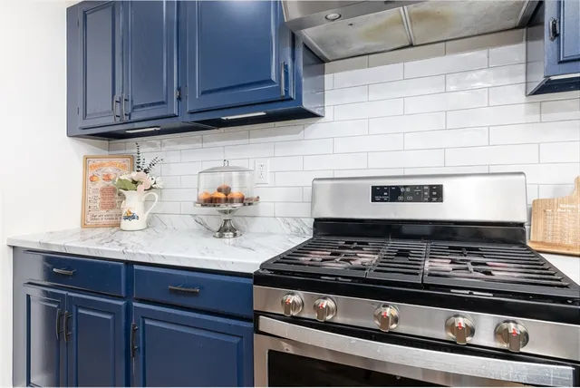 a stove top oven sitting inside of a kitchen