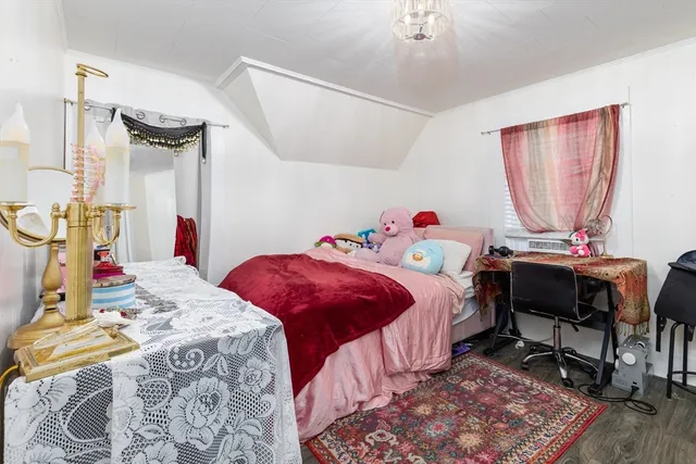 a bedroom with a bed a table and chair