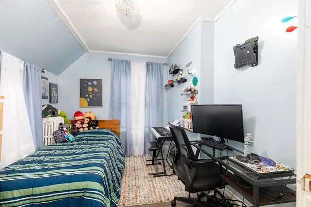 a bedroom with a bed and flat screen tv