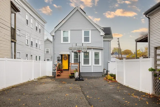 a view of a house with wooden fence