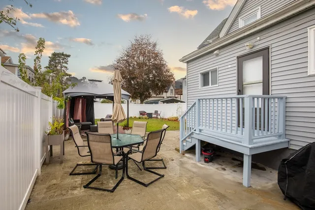 a view of a patio with a table and chairs