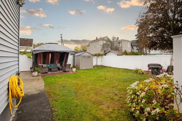 a view of a swimming pool with a table and chairs under an umbrella