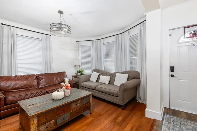 a living room with furniture and a chandelier