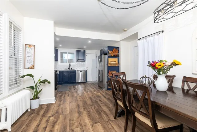 a view of a dining room with furniture and a potted plant