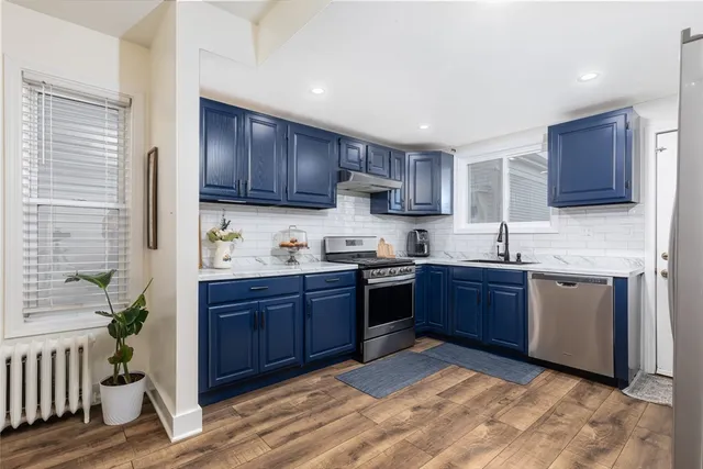 a kitchen with stainless steel appliances granite countertop a stove sink and cabinets