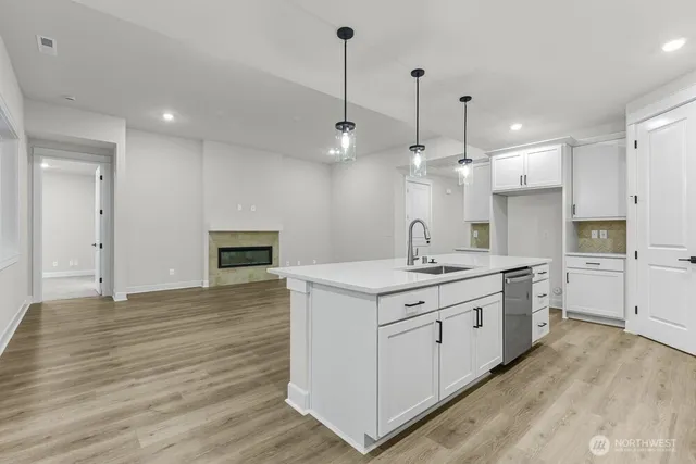a kitchen with a stove a sink and a refrigerator