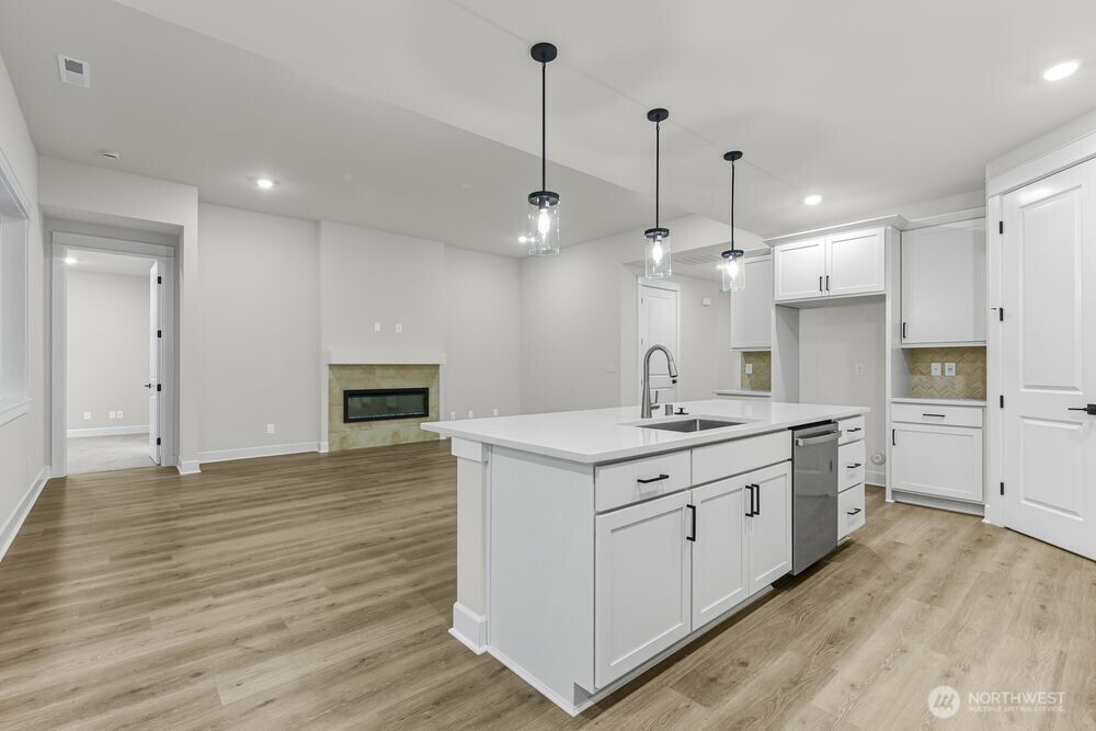 2538 Acer Loop Southeast Lacey, WA 98513 - Photo 3 of 13 a kitchen with a stove a sink and a refrigerator