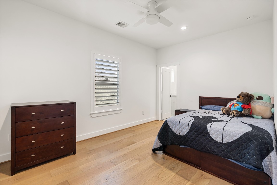 802 Aurora Street Houston, TX 77009 - Photo 16 of 23 a bedroom with a bed and dresser