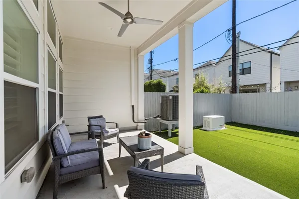 a view of a house with backyard and sitting area