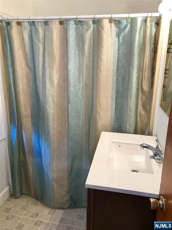 1 Cedar Lane Paramus, NJ 07652 - Photo 11 of 13 a bathroom with a sink and a mirror