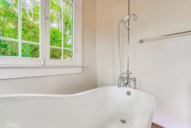 a view of an empty room and chandelier fan