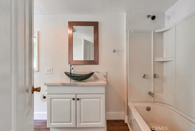an empty room with wooden floor and closet