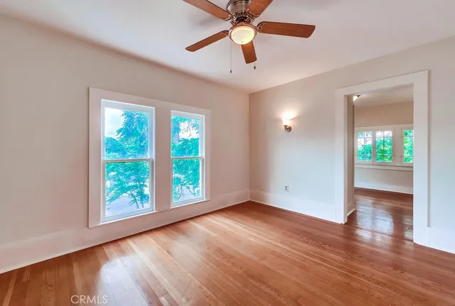 wooden floor in an empty room with a window
