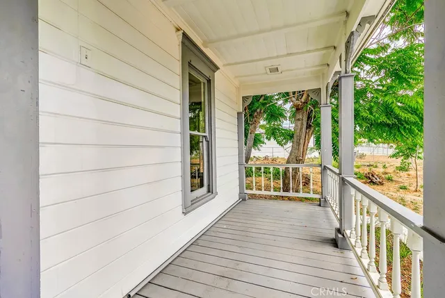 a view of a porch with wooden floor and outdoor space